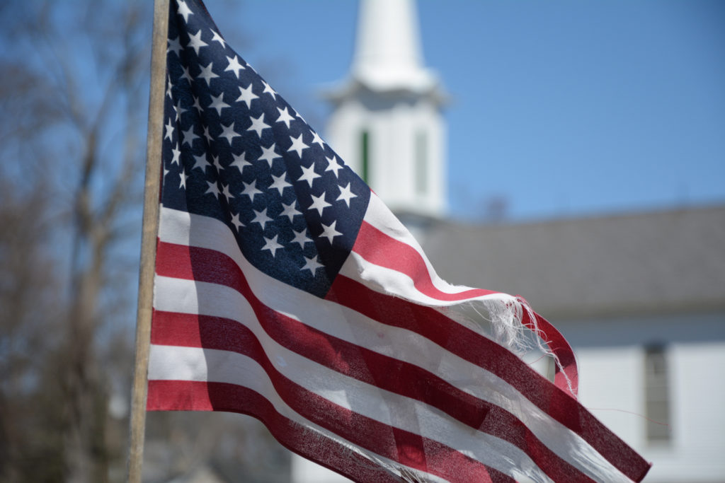 American flag flying in front of church