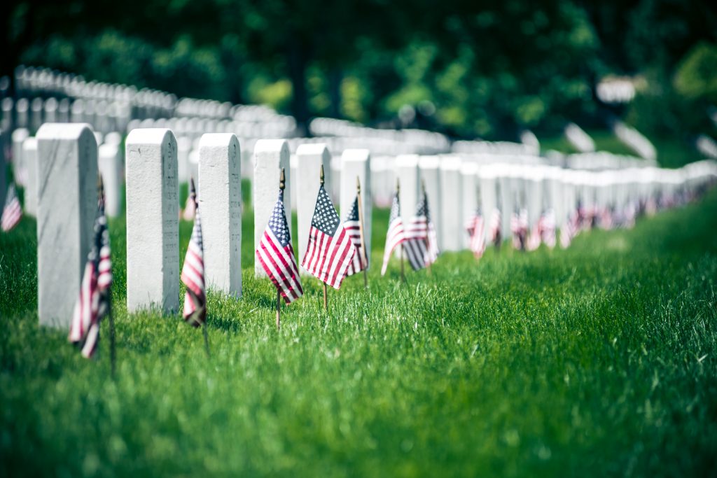 American flags by headstones on Memorial Day in Arlington National Cementery, Washington DC. USA.