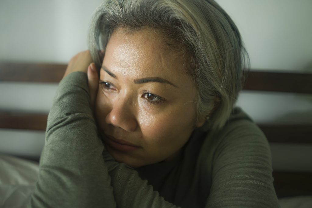 maturmiddle aged woman with grey hair sad and depressed
