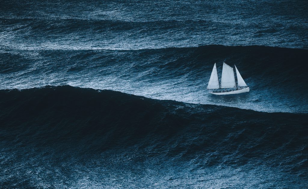 sailboat on the sea with storm and big waves, waves of grief