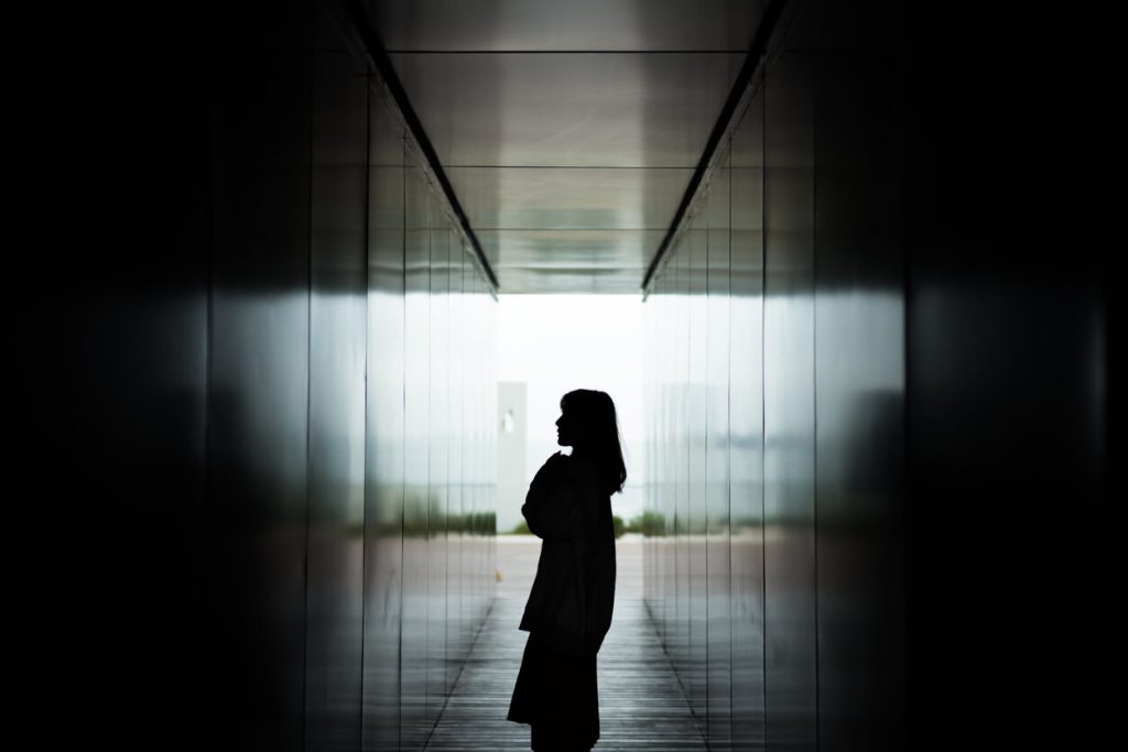 A girl in a dark hallway