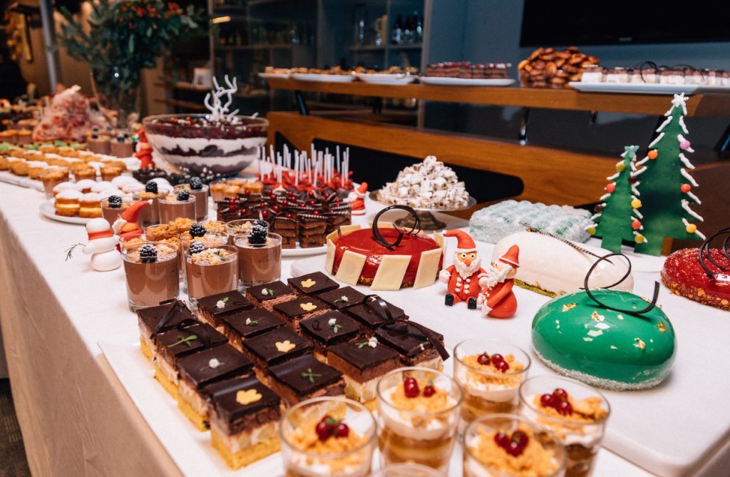 Buffet of Christmas table with different homemade desserts, cakes and sweets-over